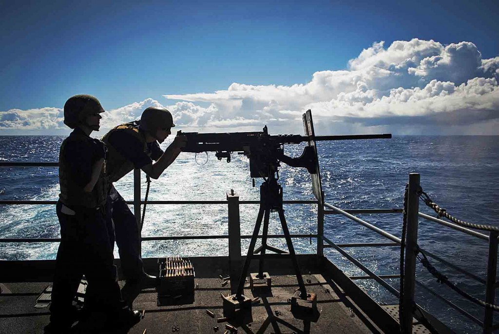 140829-N-HD510-084  PACIFIC OCEAN (Aug. 29, 2014) Gunnerâ€™s Mate 2nd Class Ashley Jebens, from Devine, Texas, observes Aviation Ordnanceman Airman Joel Ochoa, from Riverside, Calif., fire an M2HB .50-caliber machine gun from the fantail of the aircraft carrier USS Carl Vinson (CVN 70). Carl Vinson is underway in the U.S. 3rd Fleet area of responsibility. (U.S. Navy photo by Mass Communication Specialist 2nd Class Scott Fenaroli/Released)