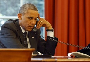 U.S. President Obama speaks on the phone with Jordan's King Abdullah at the Oval Office of the White House in Washington