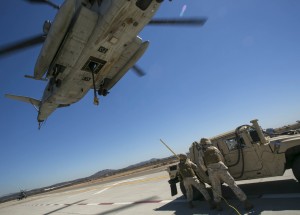 A CH-53E Super Stallion prepares to lift an armored vehicle during the Marine Air Ground Task Force demonstration, one of many performances during the 2014 Miramar Air Show aboard Marine Corps Air Station Miramar, Calif., Oct. 4. Aircraft like the Super Stallion provide necessary support for troops on the ground conducting specific missions overseas. (U.S. Marine Corps photo by: Cpl. Reba James/Released)