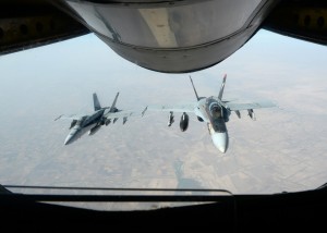 A formation of U.S. Navy F-18E Super Hornets supporting operations against ISIL, leaves after receiving fuel from a KC-135 Stratotanker over Iraq, Oct. 4, 2014. (U.S. Air Force photo by Staff Sgt. Shawn Nickel)