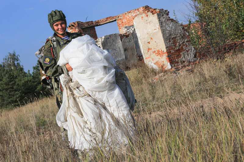 Female airborne forces cadet folding her parachute.