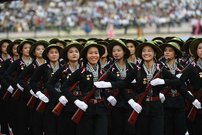 Women dressed as female Vietcong soldiers participate in a military parade in Dien Bien Phu. May 7, 2014.