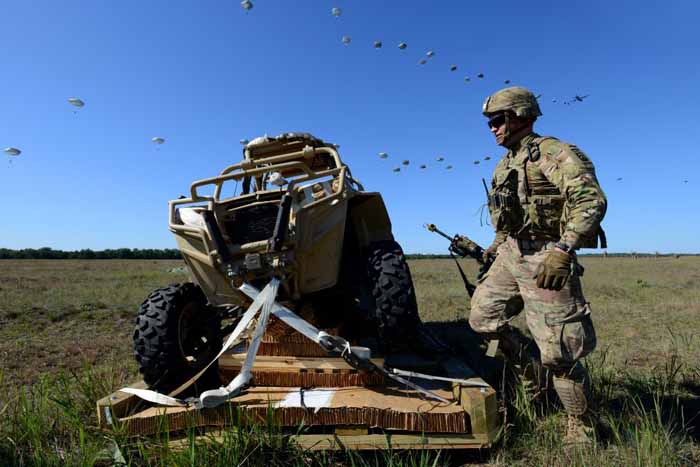  Soldiers weren’t the only ones dropped from the sky. Here, a US soldier prepares to untie a vehicle that had been dropped onto the drop zone.