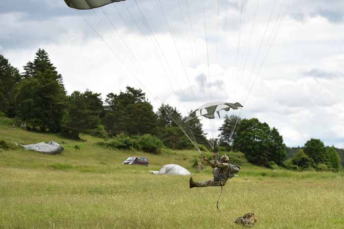  A US paratrooper with the 82nd Airborne Division lands with his parachute.